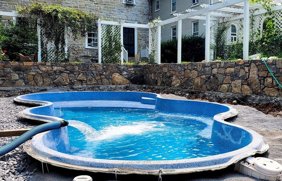 An in-ground pool getting filled with water | Solar covers for your pool | Taylor Farms Water Hauling